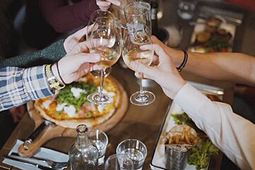 A group of people toasting with wine glasses with the letter j on them