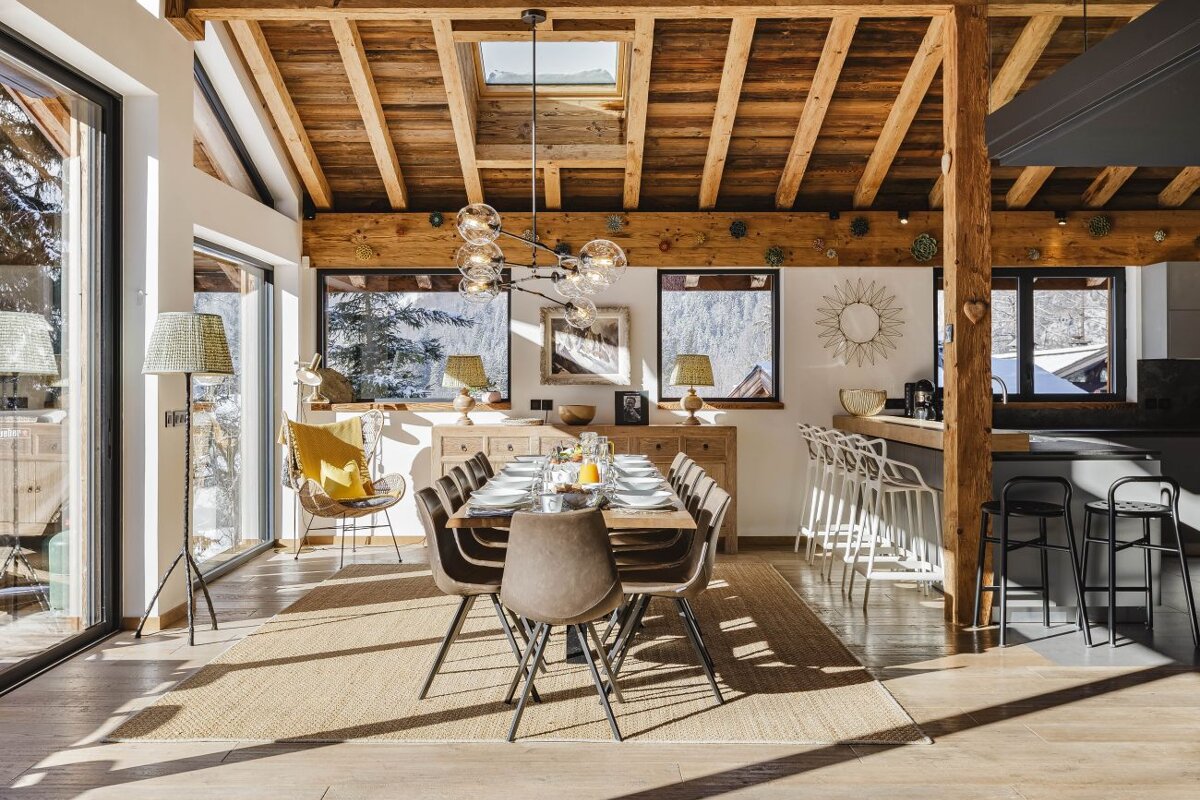 A dining room with a long table and chairs
