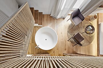An aerial view of a bathroom with a bathtub and chairs