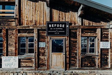 A wooden building with a sign that says refuge on it