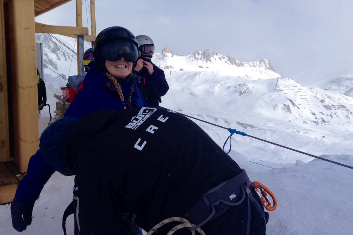 a woman being strapped into a harness