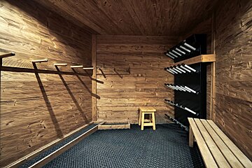 A room with wooden walls and a stool