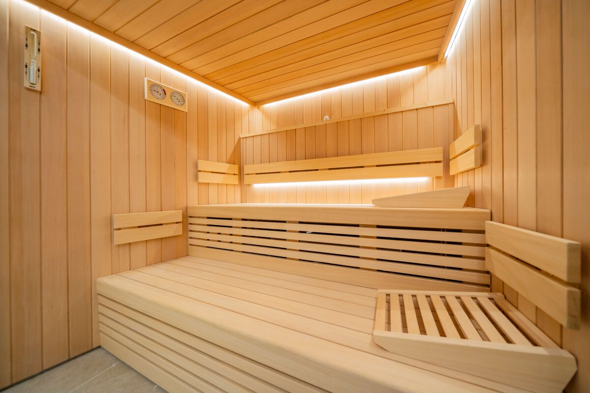 A wooden sauna with a thermometer on the wall