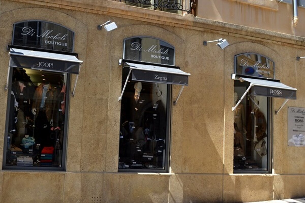 Image of a store front with black canopys and displays in the windows