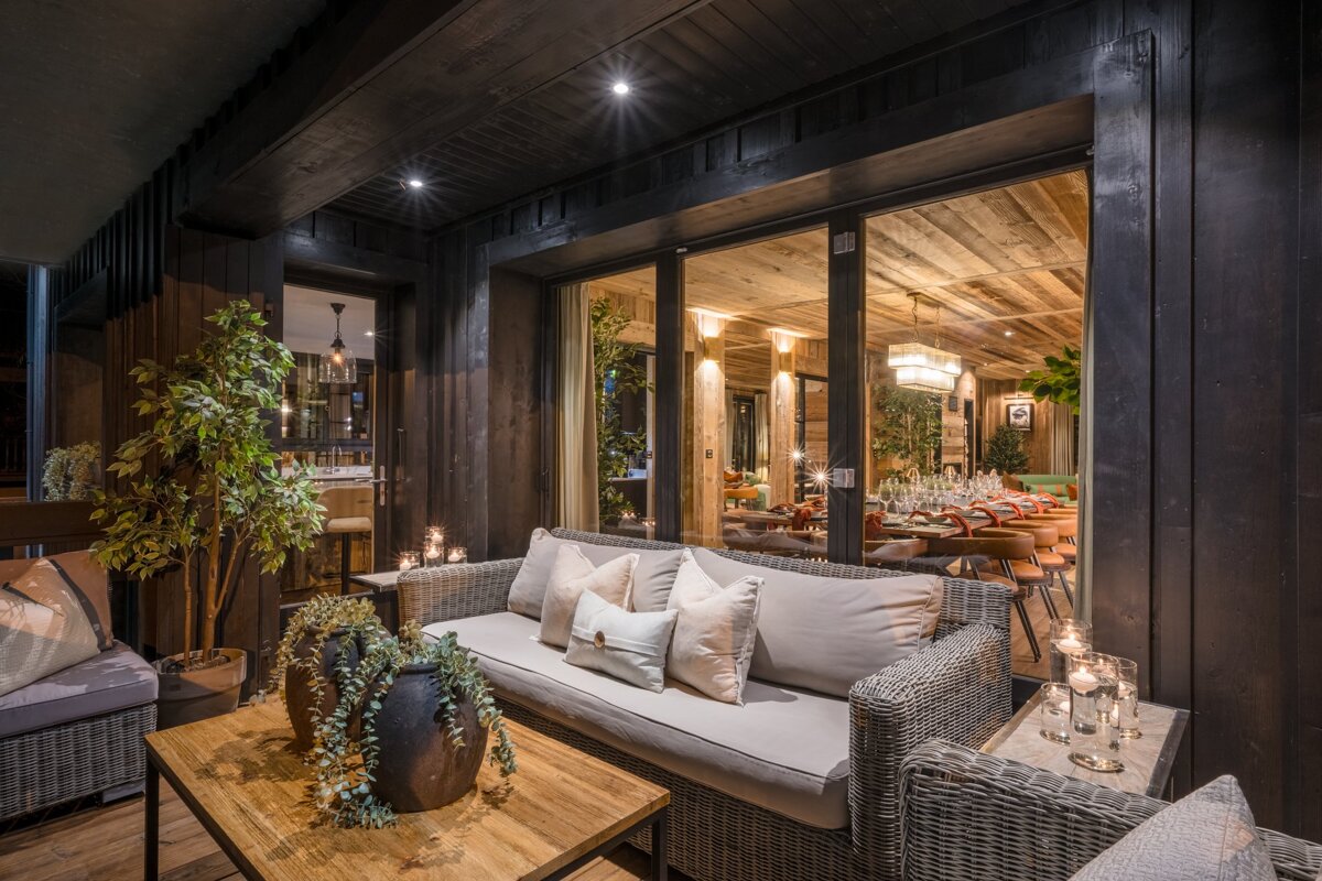 A living room with a couch and chairs and a table with candles on it