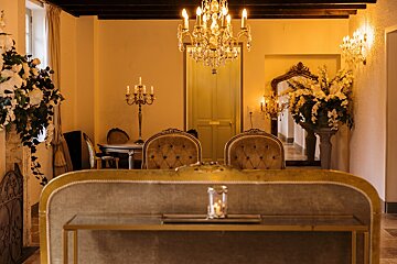 A room with a yellow door and a chandelier