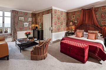 A bedroom with a bed a chair and a coffee table