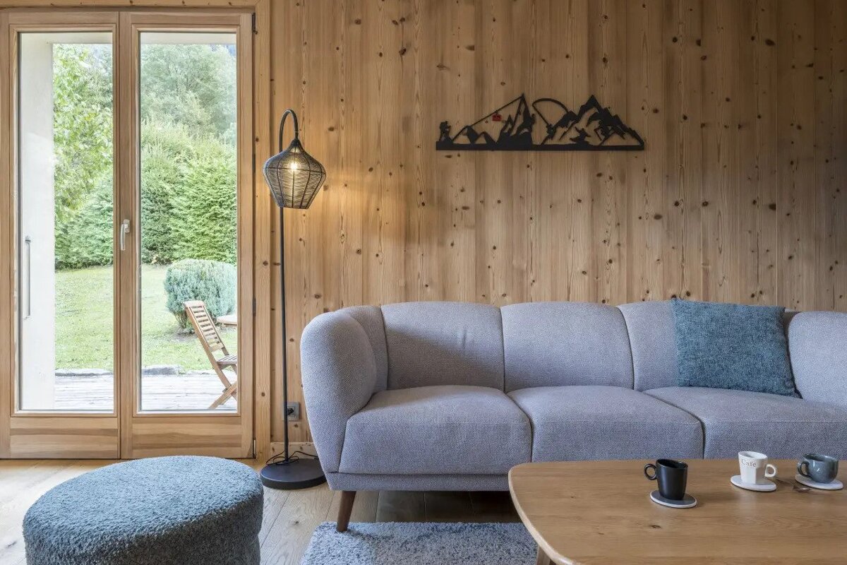 A living room with a couch and a lamp