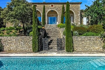 a stone house and pool