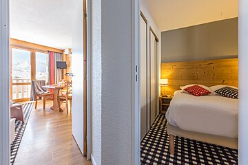 A hotel room with a bed and a table