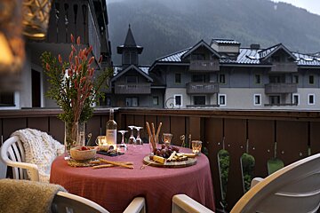 A table with a red table cloth and a bottle of wine on it