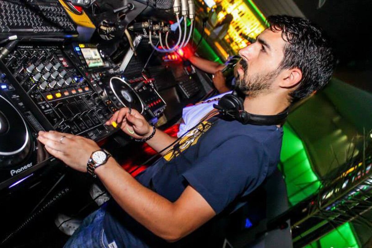 a DJ mixing at the desk in a club