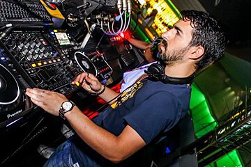 a DJ mixing at the desk in a club