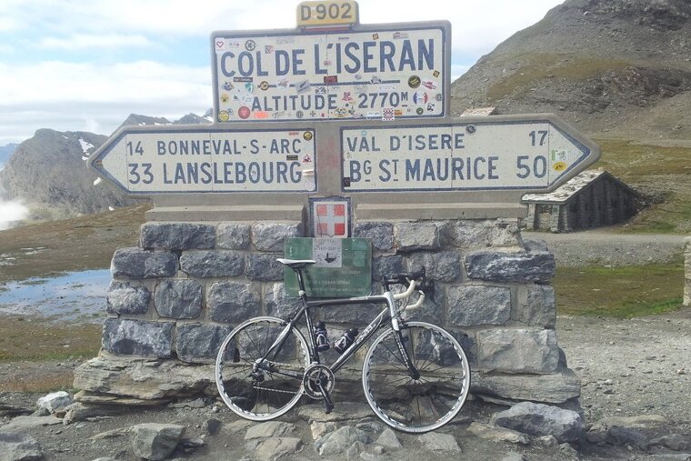 a bike resting by a sign near val disere