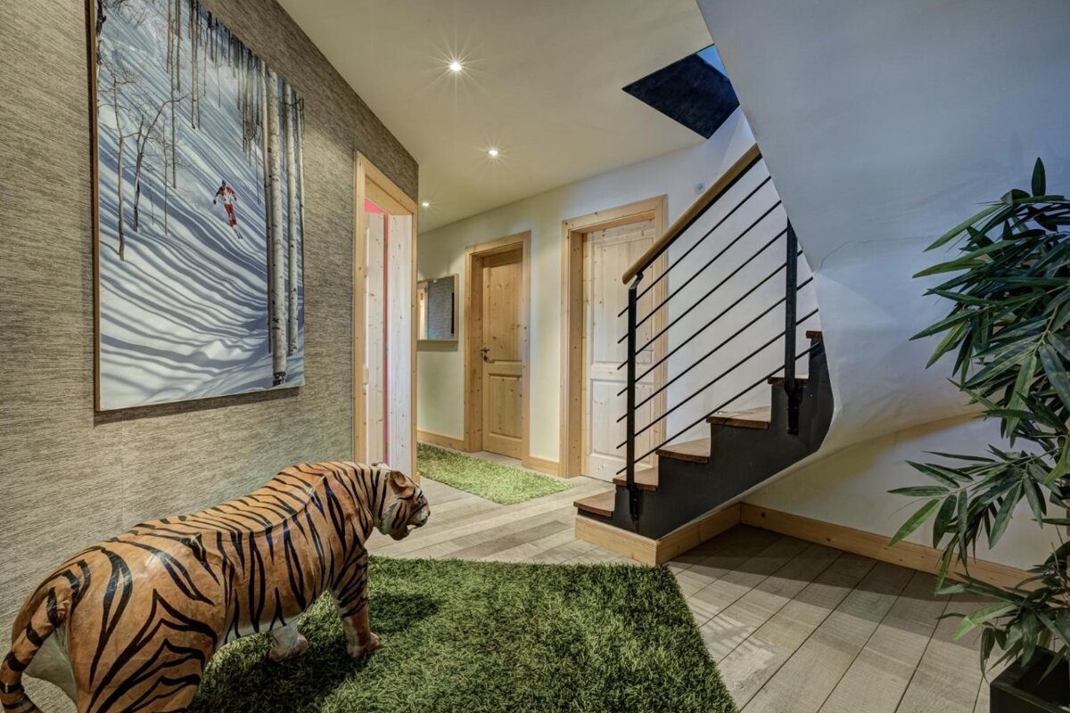 A statue of a tiger in a hallway next to a staircase