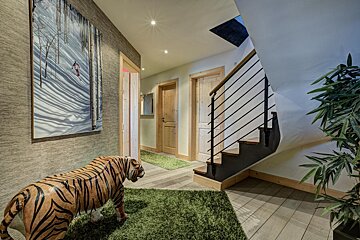 A statue of a tiger in a hallway next to a staircase