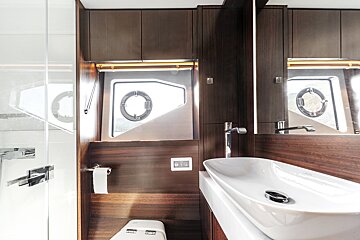 A bathroom with a toilet and a sink and a mirror