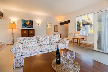 A bottle of wine sits on a table in a living room