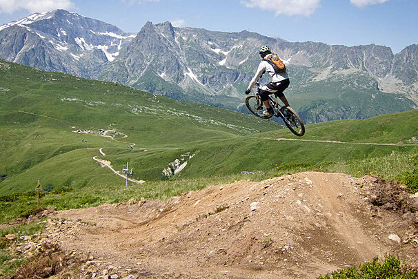a man on a bike flying off a hip