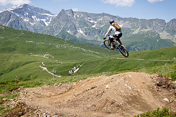 a man on a bike flying off a hip
