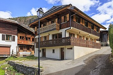 A house with a sign on the side that says ' a ' on it