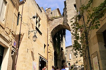 a tall gateway on narrow lane in st emilion