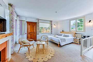 A bedroom with a large bed and a large window