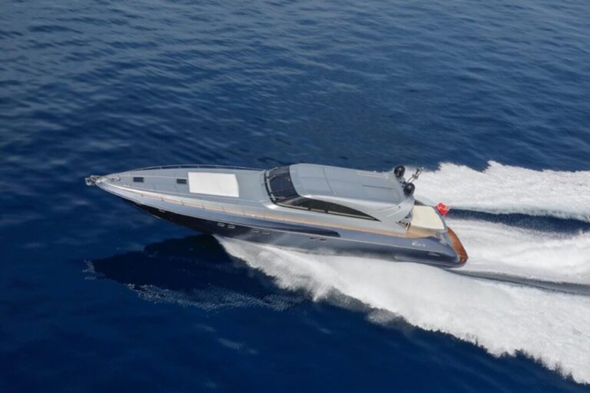 A boat with a red flag on the side is floating in the ocean