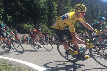 cyclists on a corner of the tour de france