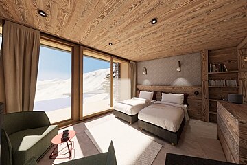 A cozy, wood-paneled room with twin beds, large windows showcasing a snowy mountain view, and a comfy sitting area.