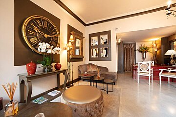 A living room with a large clock on the wall and a couch