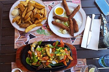 three plates of food on a table in a restaurant