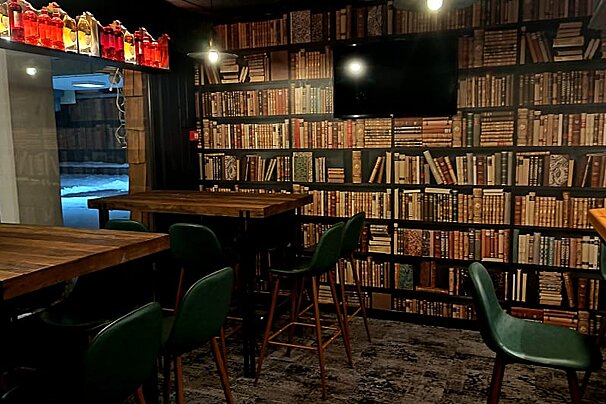 A room filled with bookshelves and tables and chairs