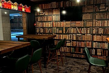 A room filled with bookshelves and tables and chairs