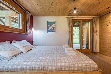 A bedroom with a large bed and a picture on the wall that says mont blanc