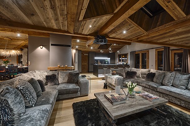 A living room with a large sectional couch and a coffee table