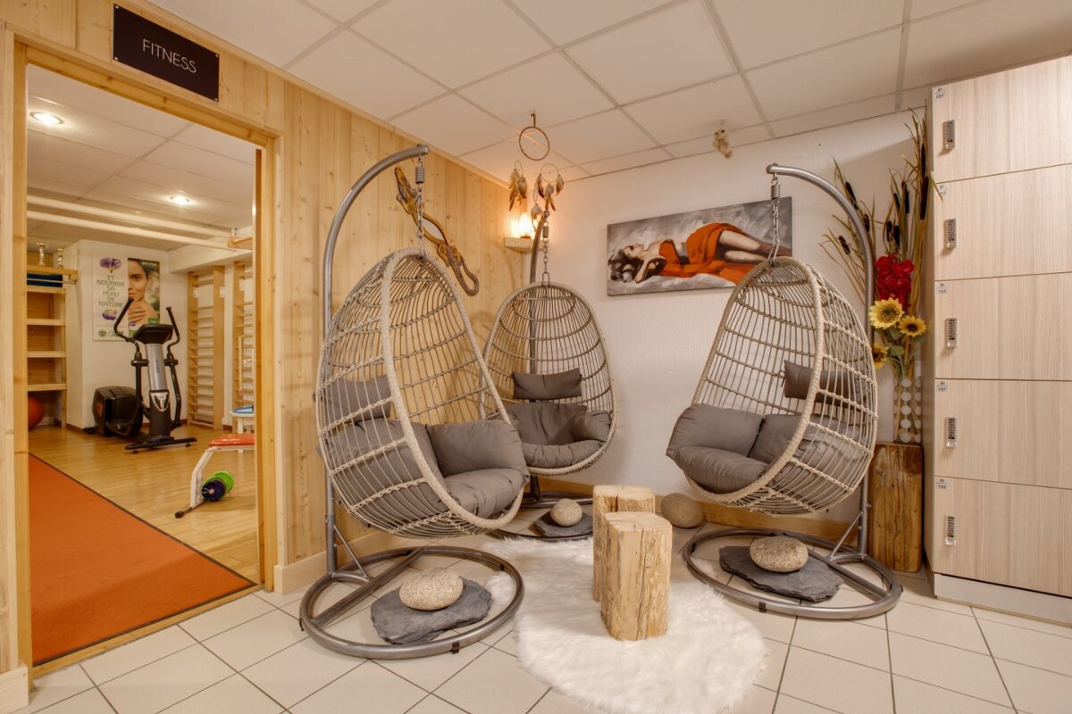 A room with hanging chairs and a sign that says fitness