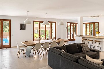 A living room with a couch and a dining table