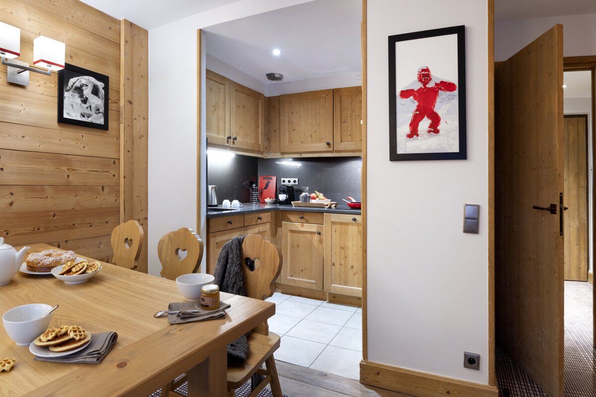 A kitchen with a picture of a child on the wall