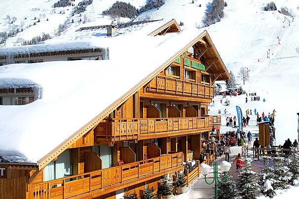 A large wooden building with the word hotel on it