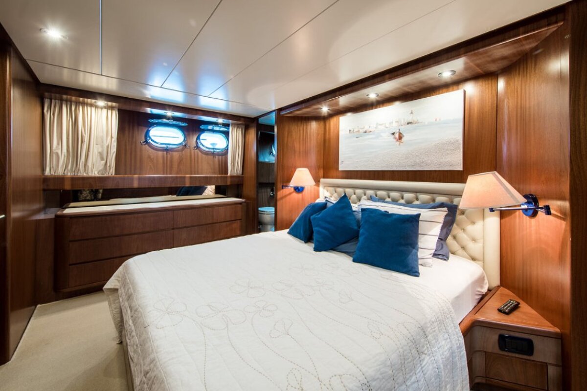 A bedroom with a large bed and blue pillows