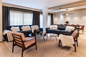 A living room with a couch and two chairs