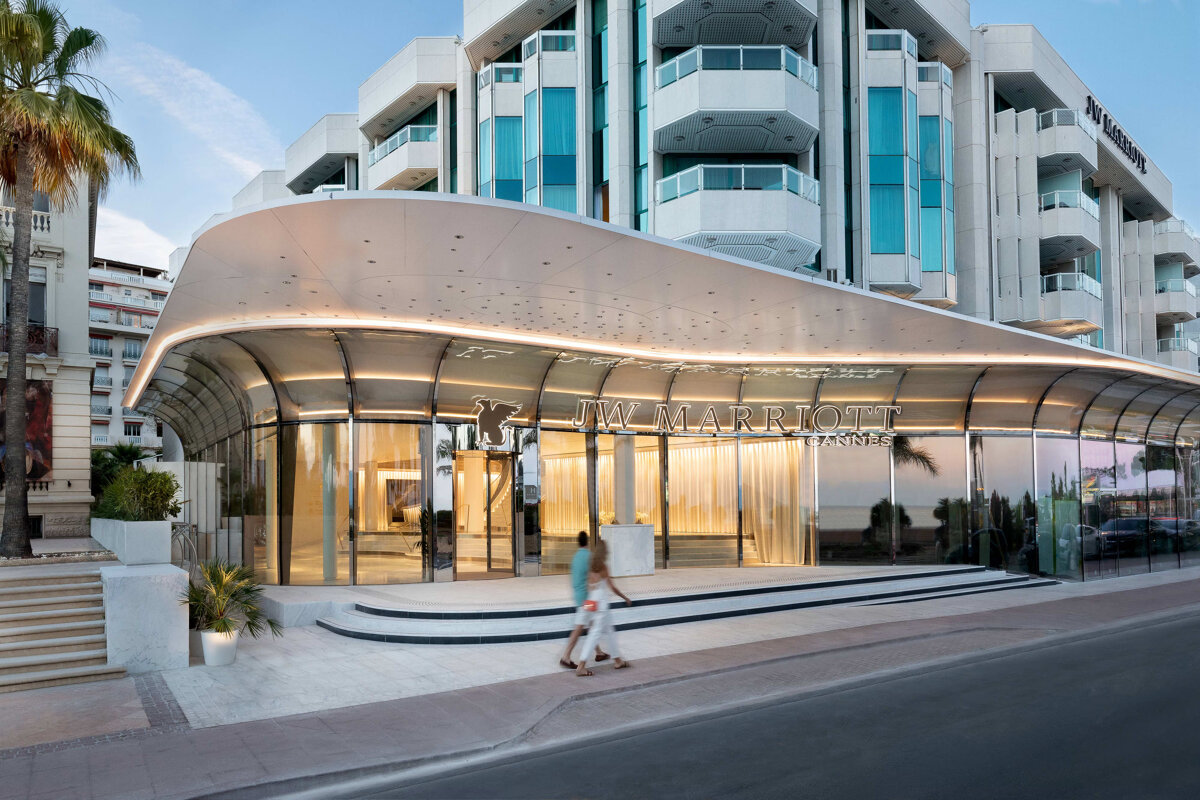 A man walks past the entrance to a marriott hotel