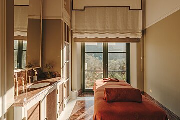 A bathroom with a sink and a massage table