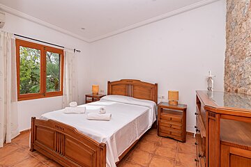 A bedroom with a large bed and two nightstands