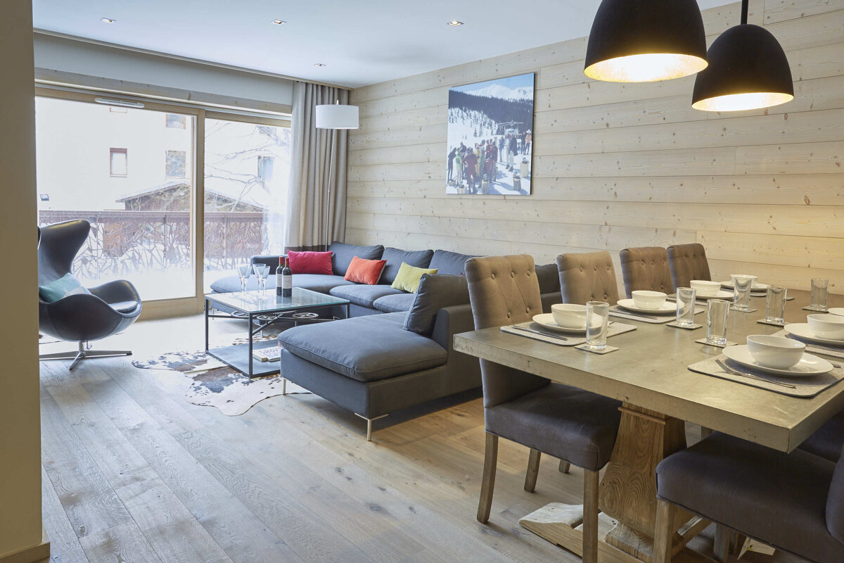 A living room with a dining table and chairs