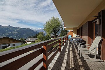 A balcony with a view of a mountain range
