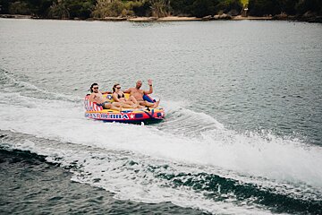 A group of people are riding a boat that says giant bubba