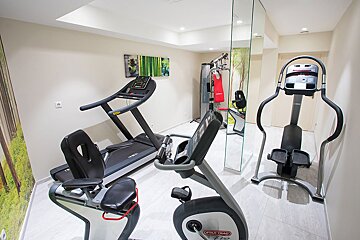 A gym with a treadmill and a star trac exercise bike