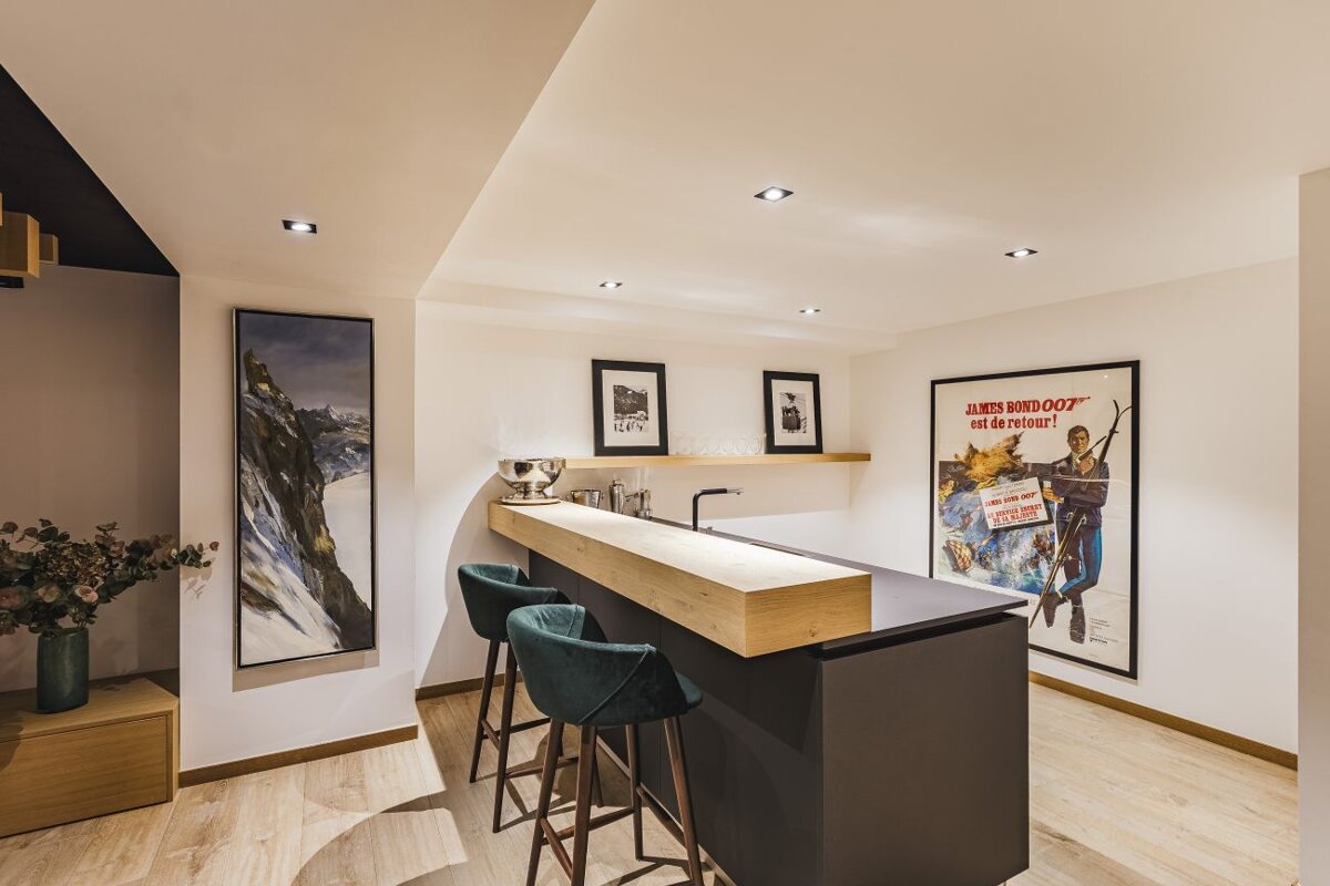 A james bond 007 movie poster hangs above a bar